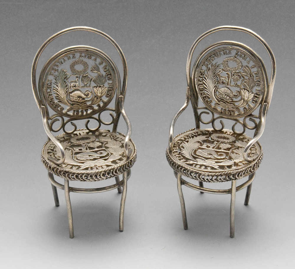 A pair of toy or miniature pierced coin set chairs. Height measuring 7.5 cm, gross weight 85