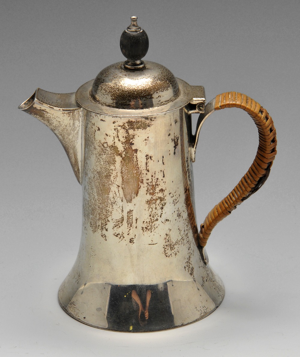 A George V silver hot milk jug, of trumpet form with domed cover and woven handle. Hallmarked