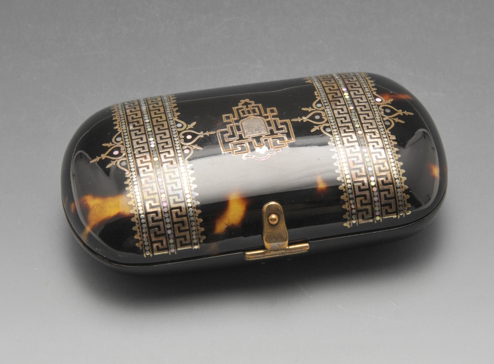 A French mother-of-pearl inlaid tortoiseshell purse, of bulging oblong form having elaborate Greek-