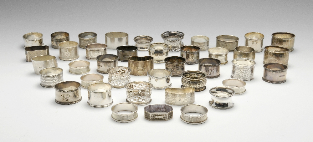 A selection of forty Victorian and later silver napkin rings of various styles, many with personal