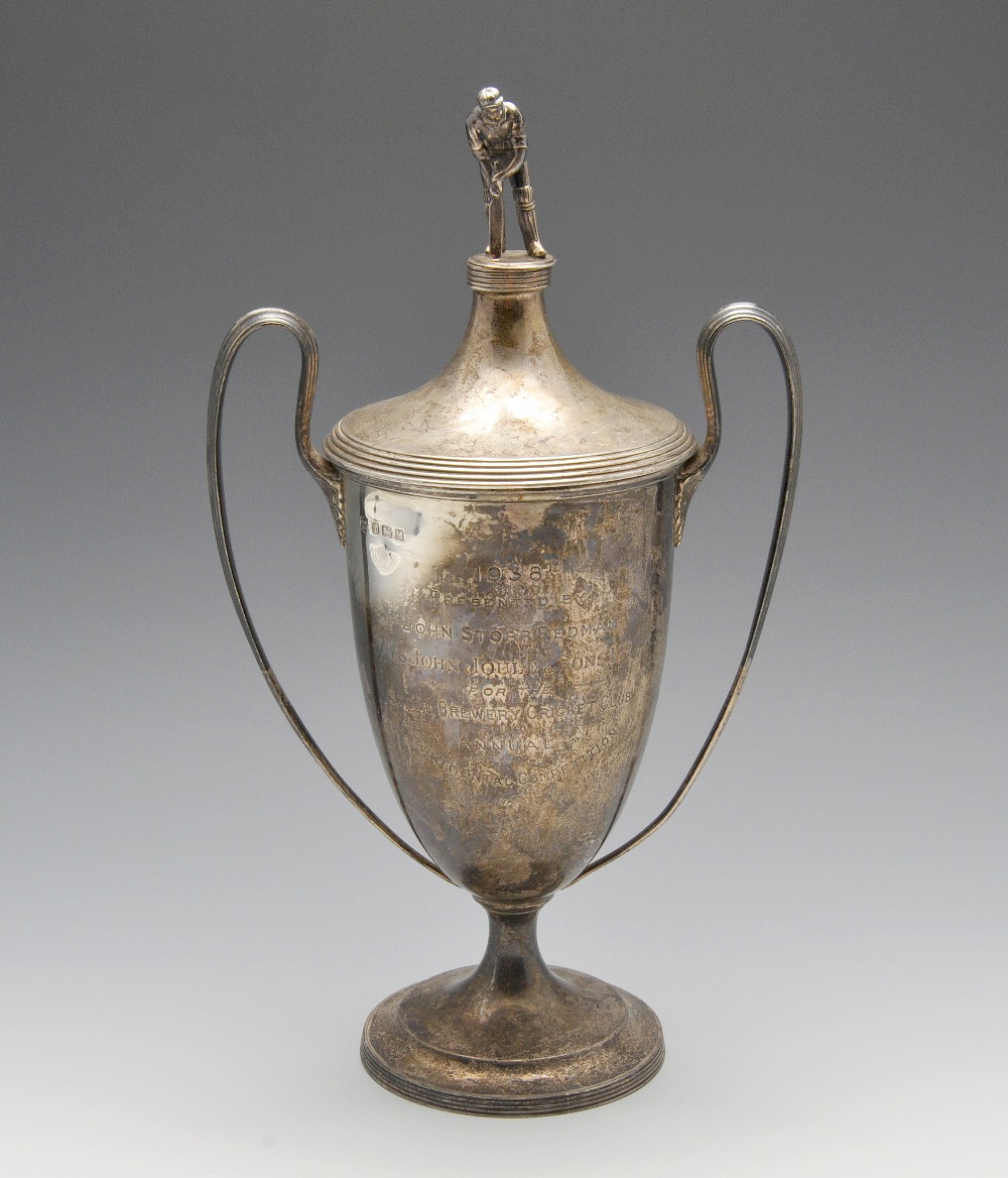 A 1930's silver twin-handled trophy cup and cover, of tapering form with presentation engraving to