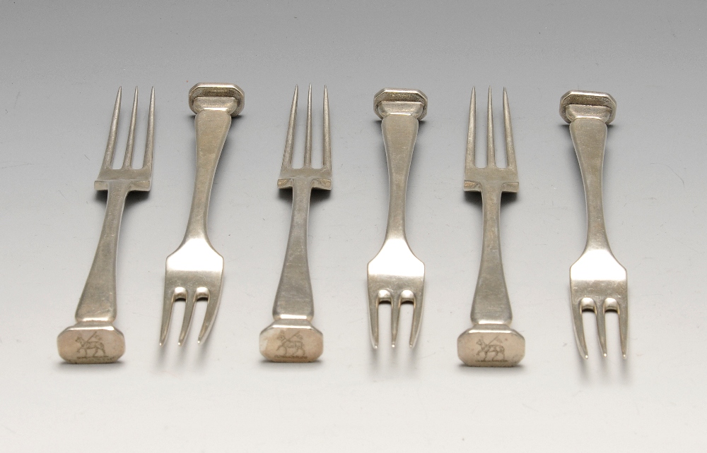 An early twentieth century set of six silver three-tine forks with crested seal terminals.