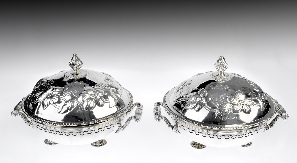 A matched pair of early nineteenth century Irish silver entree dishes, each of circular form with