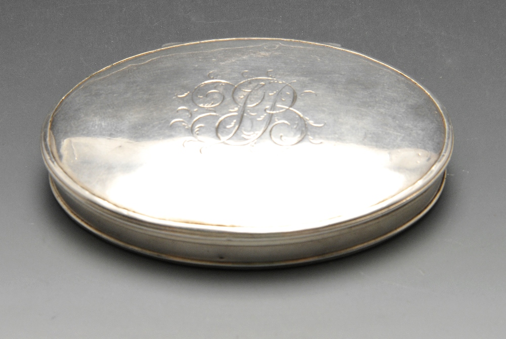 An oval snuff box, probably eighteenth century, the plain slim form with engraved monogram to both