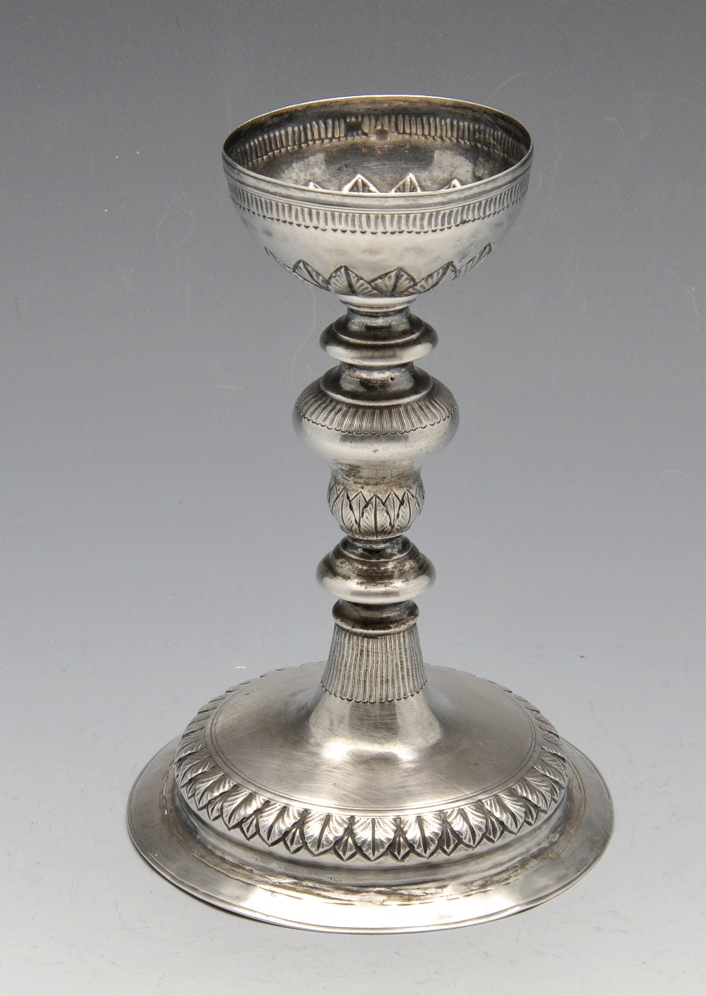 A continental chalice with circular base rising to a knopped column and a bowl shape socket,