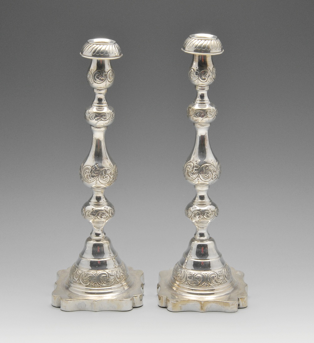 A pair of 1920's Judaic silver Sabbath candlesticks, each with a filled and shaped square base