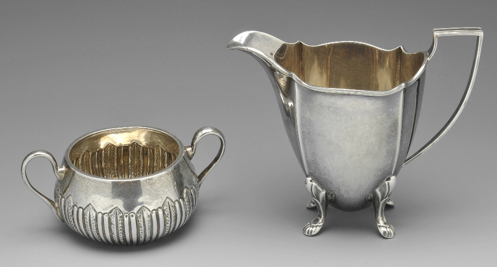 A late Victorian silver sugar bowl, the circular body part fluted with foliate accents and twin