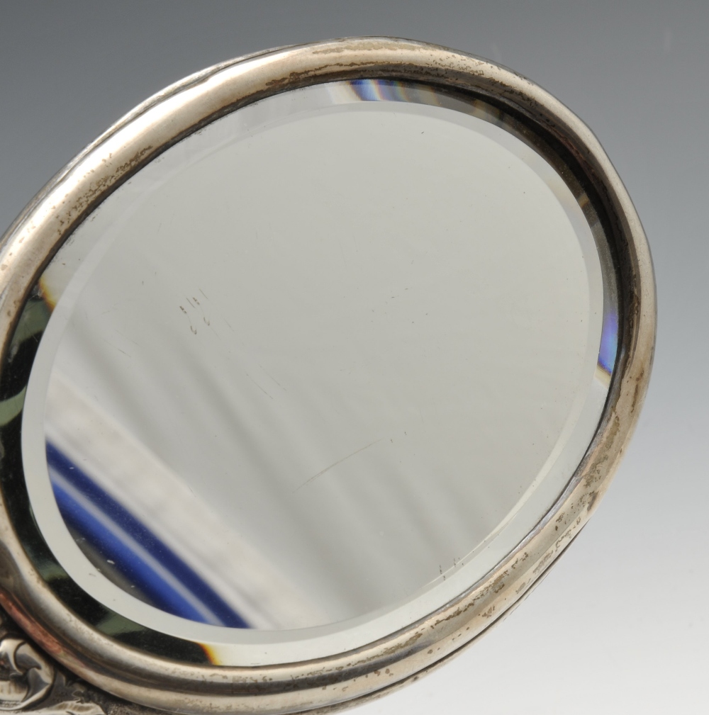 A late Victorian silver mounted hand mirror of oval form, ornately embossed throughout with - Image 4 of 8