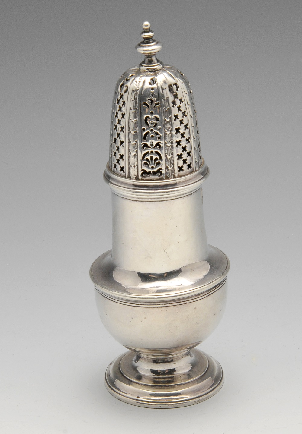 A George II silver caster of vase form with pierced cover and baluster finial. Hallmarked London