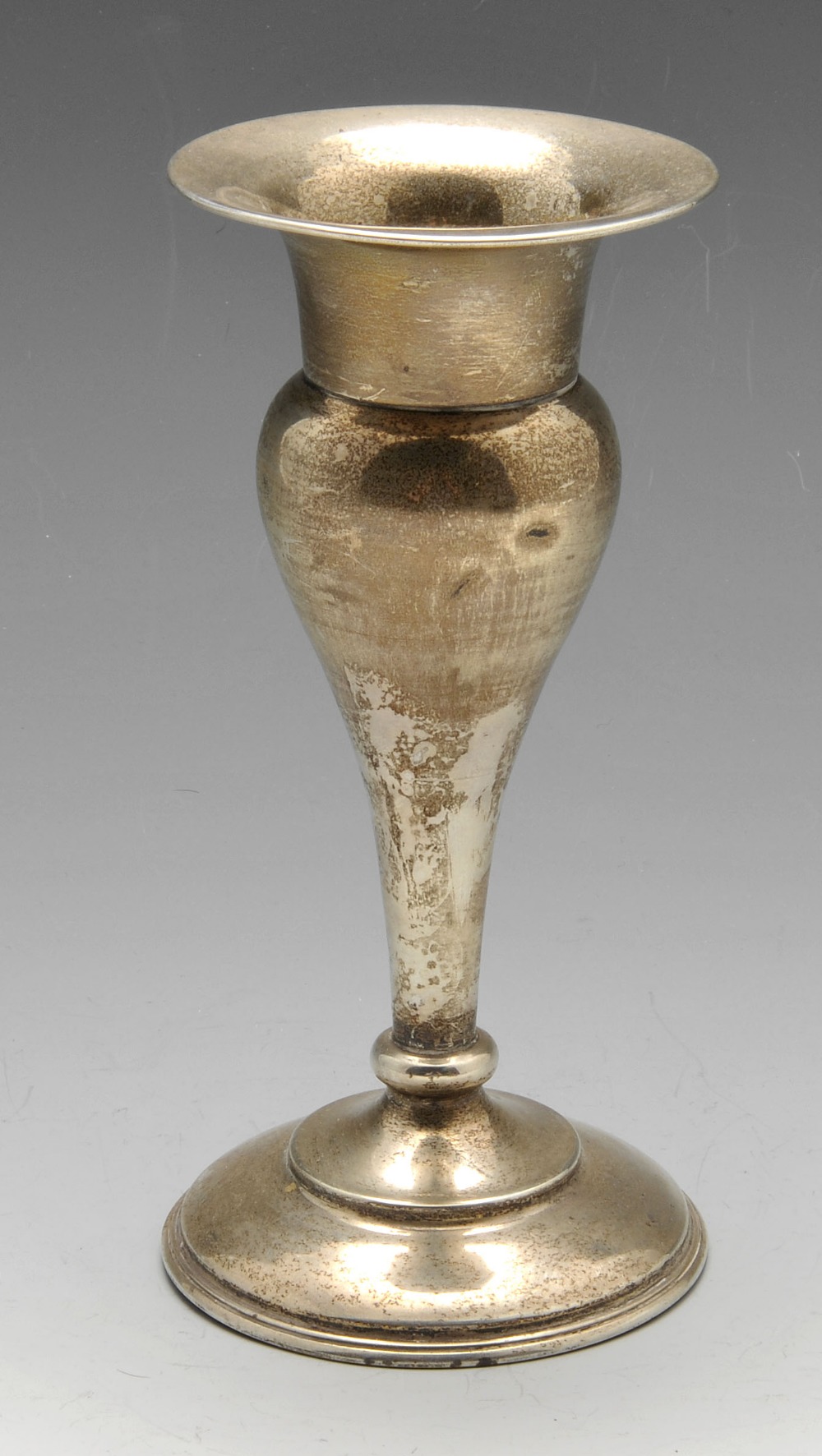 A mid-twentieth century silver bud vase of tapered form standing on a stepped weighted foot,