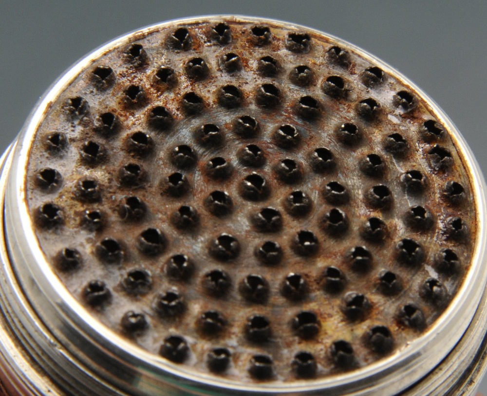 An eighteenth century nutmeg grater, the ovoid form with floral and scroll embossed decoration. - Image 3 of 4