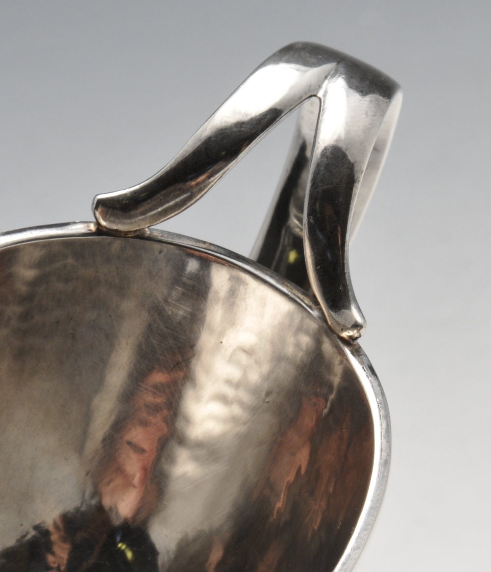 An Italian silver sauce boat of planished form with moulded rim, split loop handle and raised on - Image 5 of 5