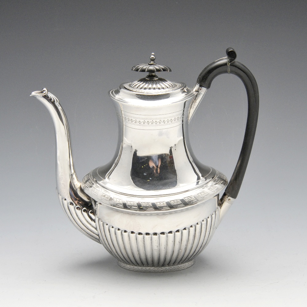 A late Victorian silver coffee pot, the oval bellied form with stipple engraved and punched