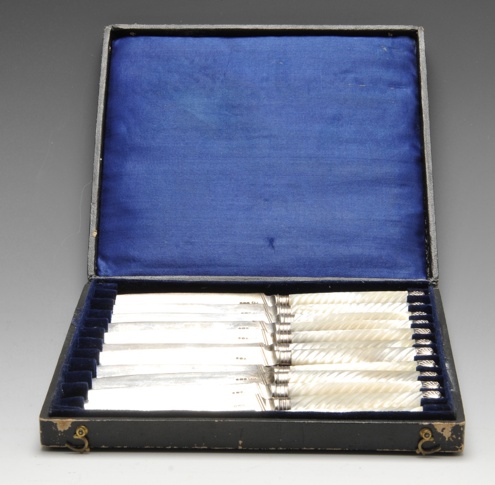 A cased composite set of twelve Georgian knives, having reeded mother-of-pearl mounted handles and