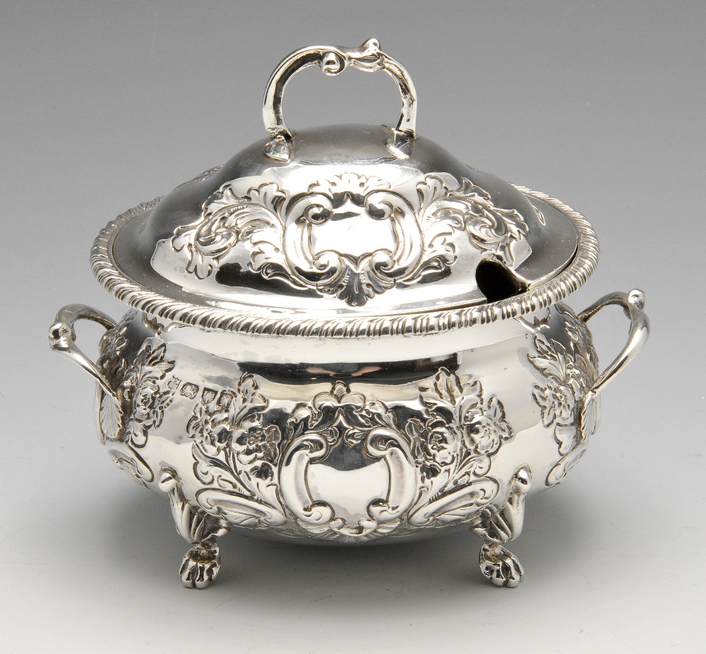 A late Victorian twin-handled silver sauce tureen and cover, of oval form having gadrooned rim and