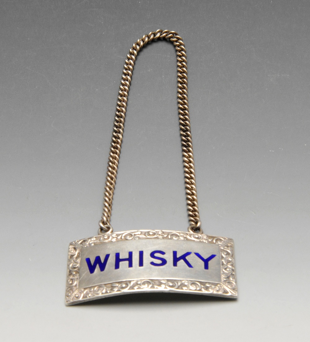 A modern silver whisky label of oblong form with enamel inlay within scroll surround. Hallmarked