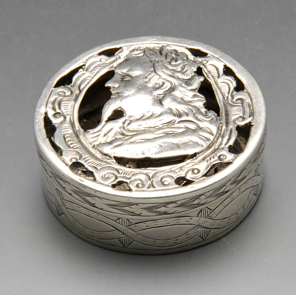A continental pomander box, possibly nineteenth century, the circular form with engraved sides and