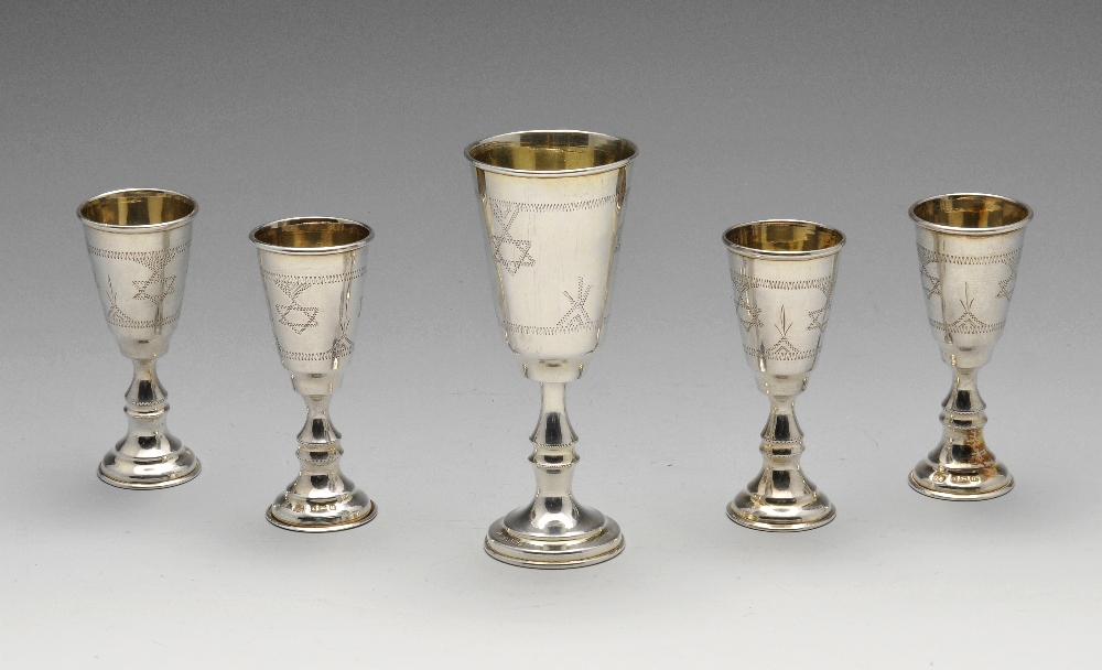 A set of four George V silver Kiddush cups, engraved with Star of David border to the tall