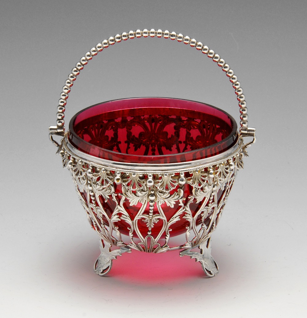 A small selection of plated items to include a pierced sugar basket with cranberry glass liner, an