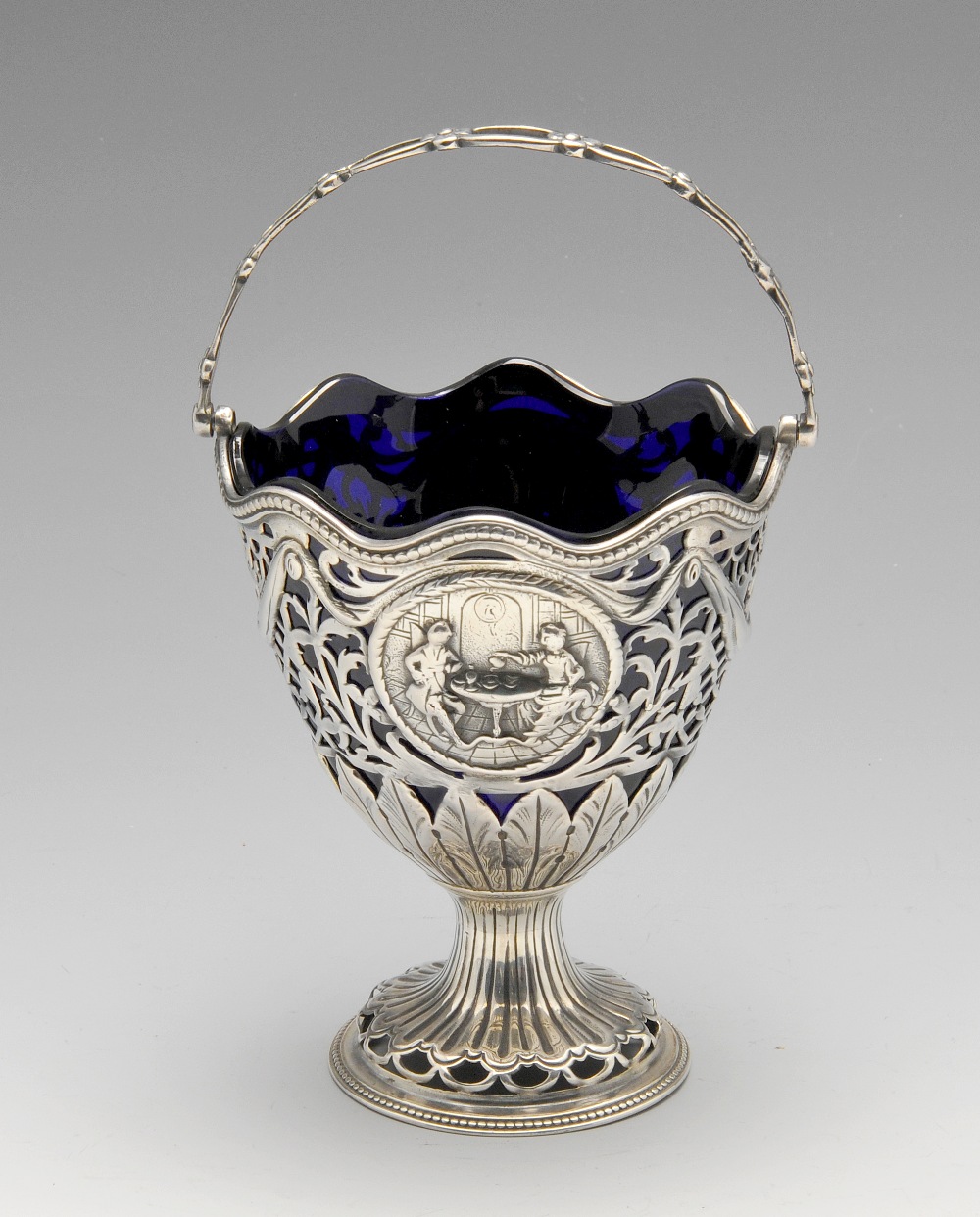 A George III silver sugar basket, the pierced form embellished with classical medallions amidst