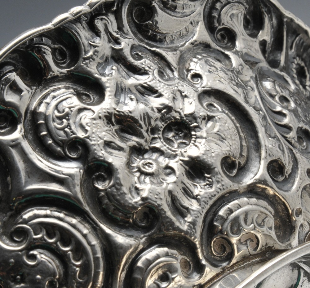 A Victorian silver dish of oval form, entirely embossed with fruiting and floral scrolls upon a - Image 3 of 4