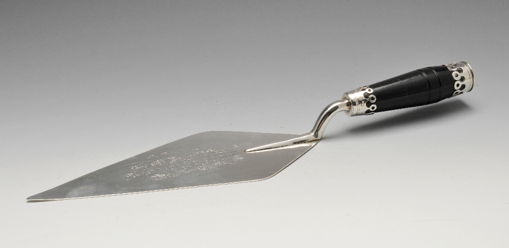 A mid-Victorian silver presentation trowel of typical form, and having a stained wood handle.