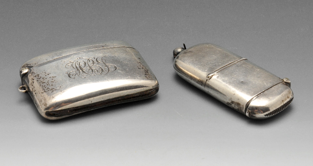 An early twentieth century silver double vesta case, the slightly curved oblong form with engraved