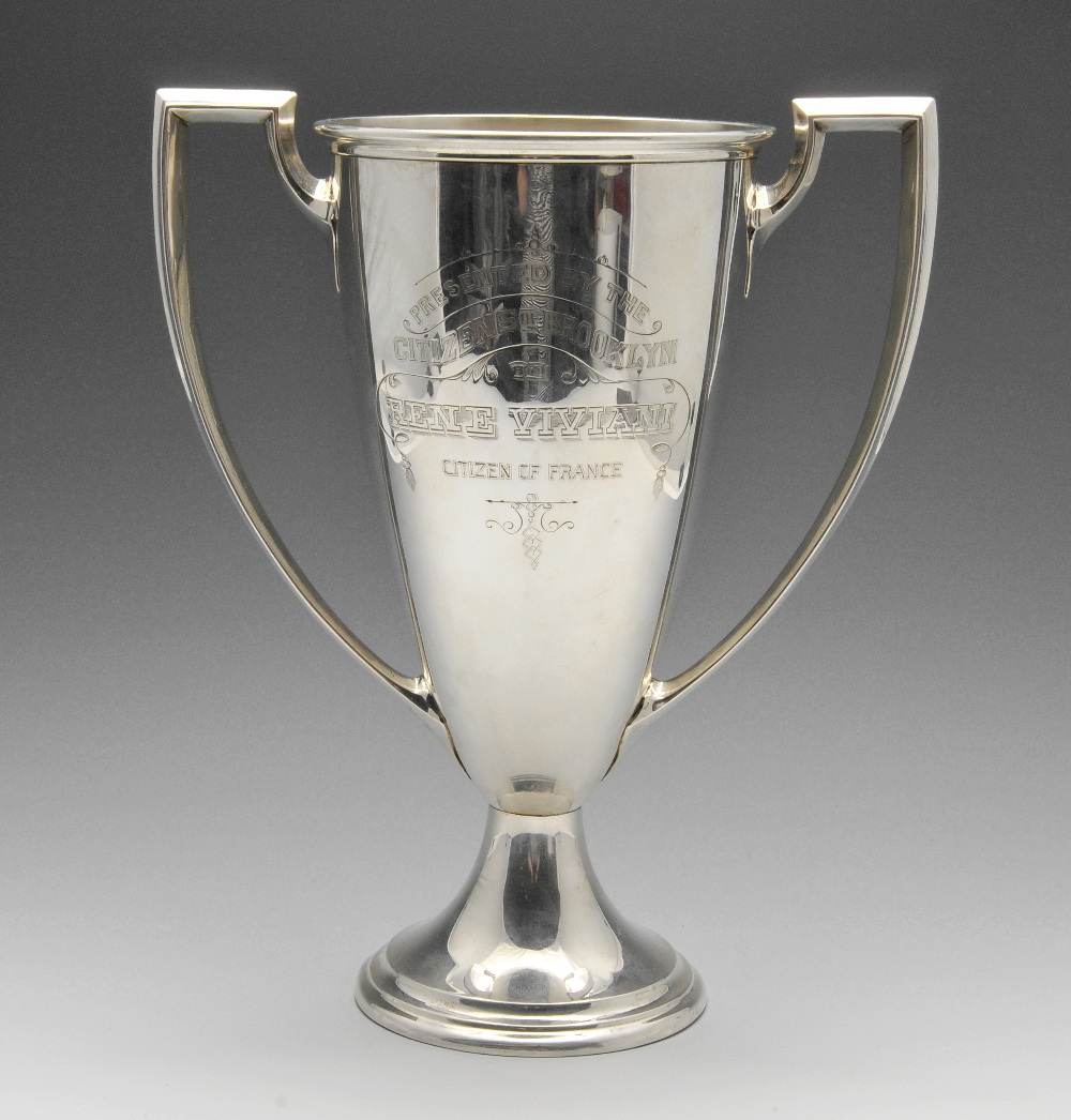 An early twentieth century large American silver trophy cup, the tapered body with presentation