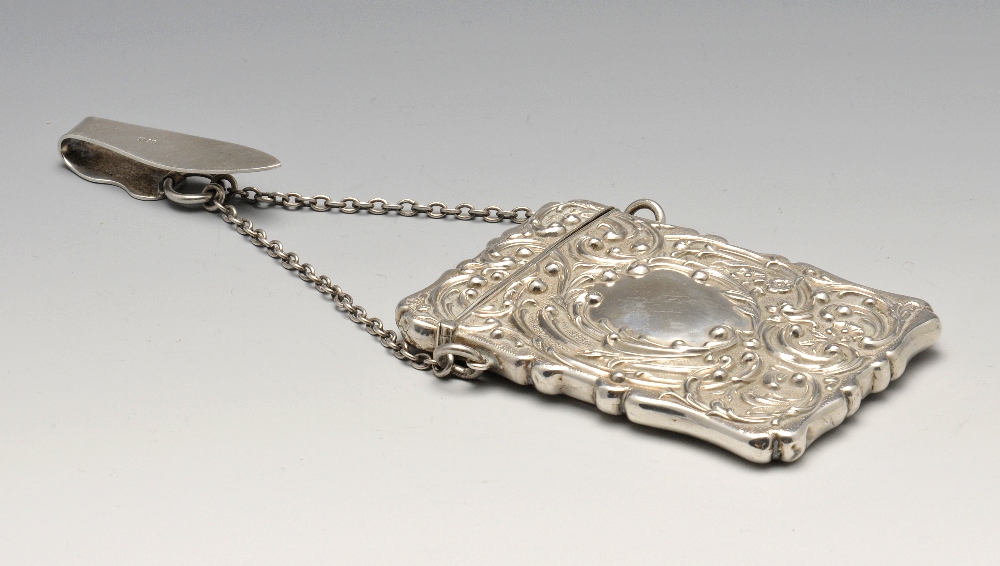 An Edwardian silver card case, the oblong form with scalloped edge and entirely embossed with floral