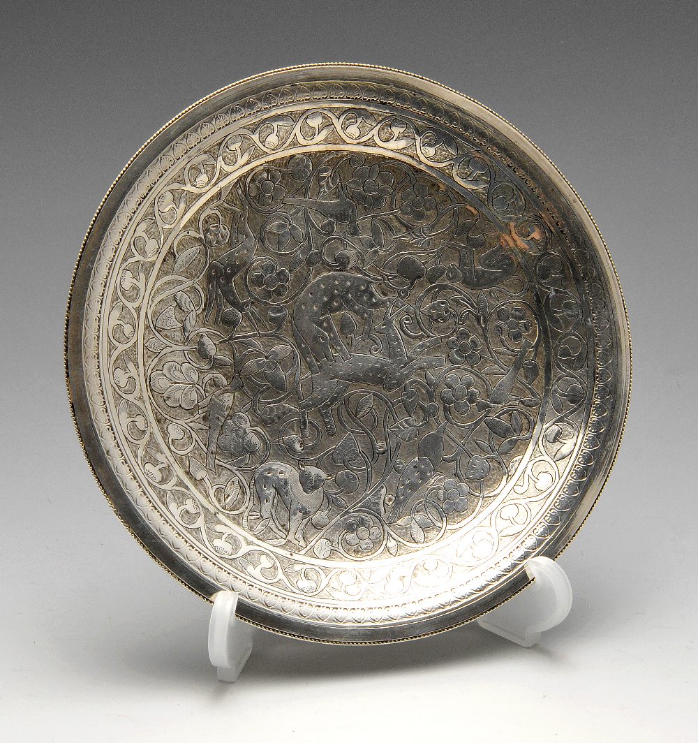 An early twentieth century Egyptian silver plate, the circular form chased with various animals