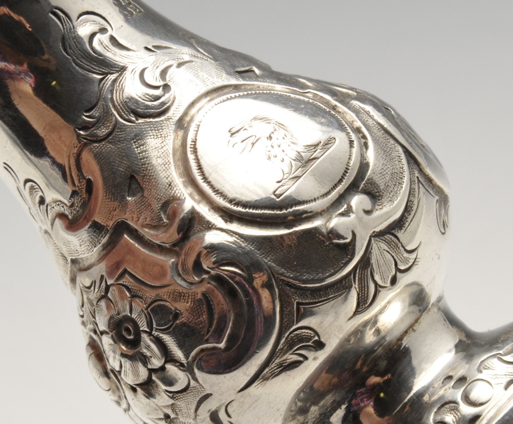 A mid-Victorian silver pepper pot with floral embossed decoration and engraved family crest, - Image 3 of 11