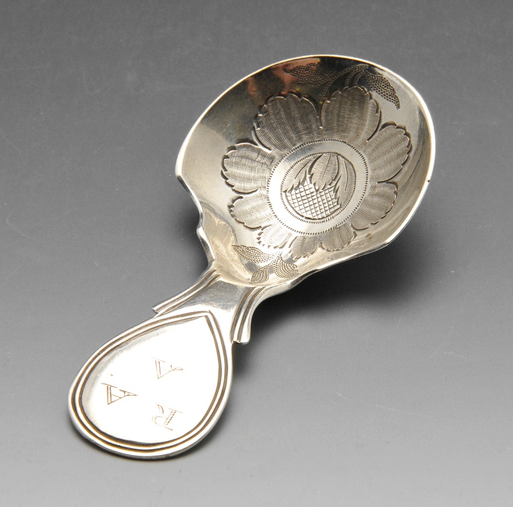 A George III silver caddy spoon, having engraved flower decoration to the bowl and initialled tear