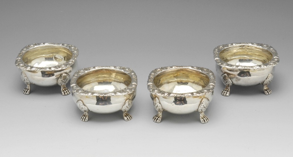 A matched set of four Georgian and Victorian open salts, each of cauldron shape with a floral scroll