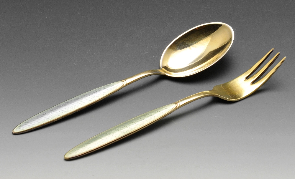 A Norwegian silver-gilt and enamel three-prong fork and spoon, having oval panels of pale green