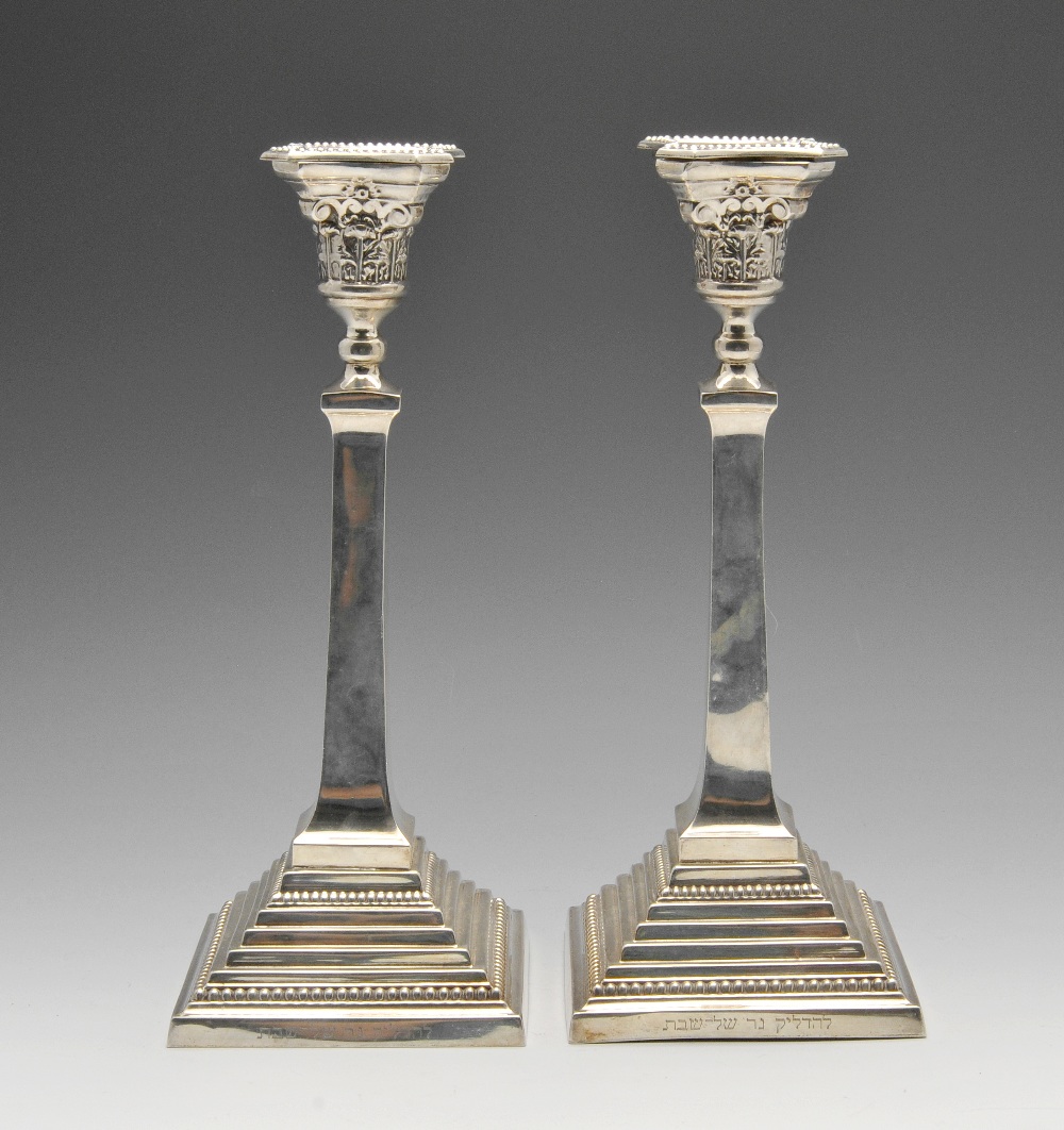 A pair of 1950's silver candlesticks, the Corinthian capitals raised on tapered square columns and