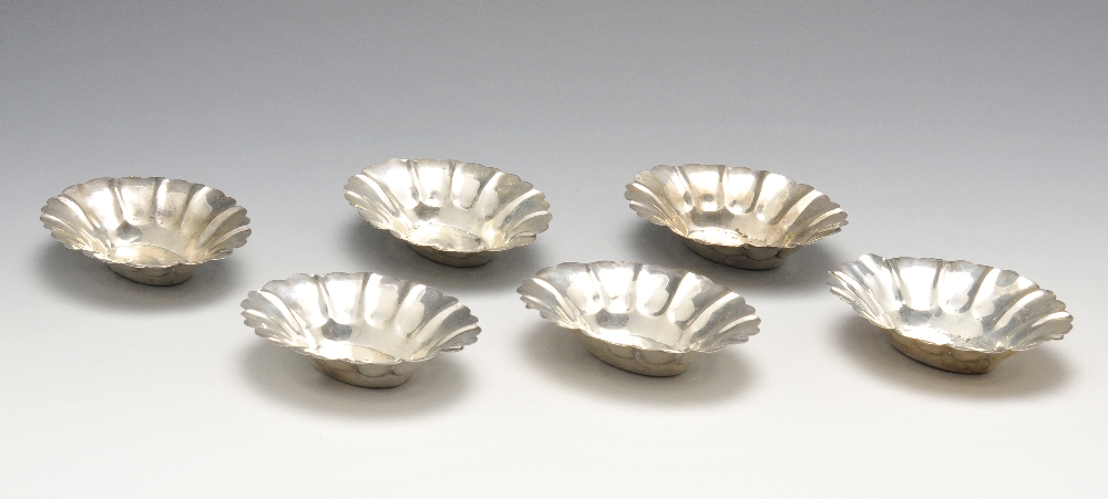 A set of six silver bonbon dishes, probably American, of oval form with flaring lobed rim. Marked