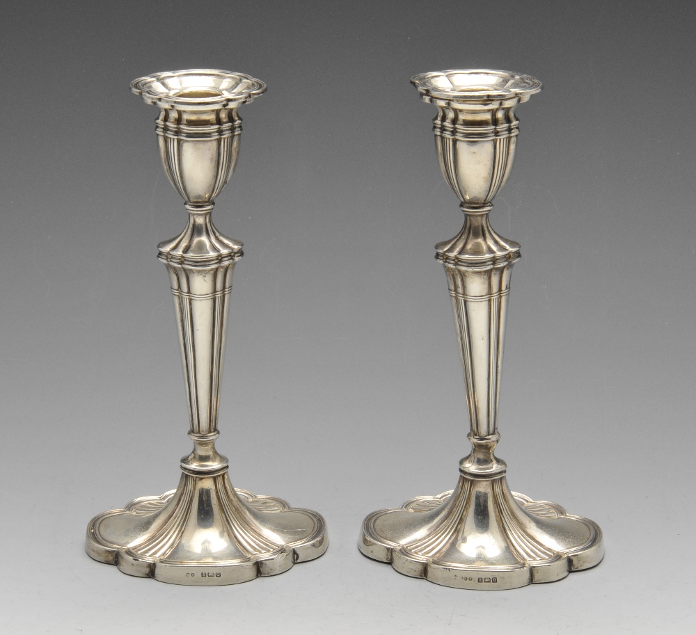 A pair of 1940's silver candlesticks, each of lobed outline with curved and filled base rising to