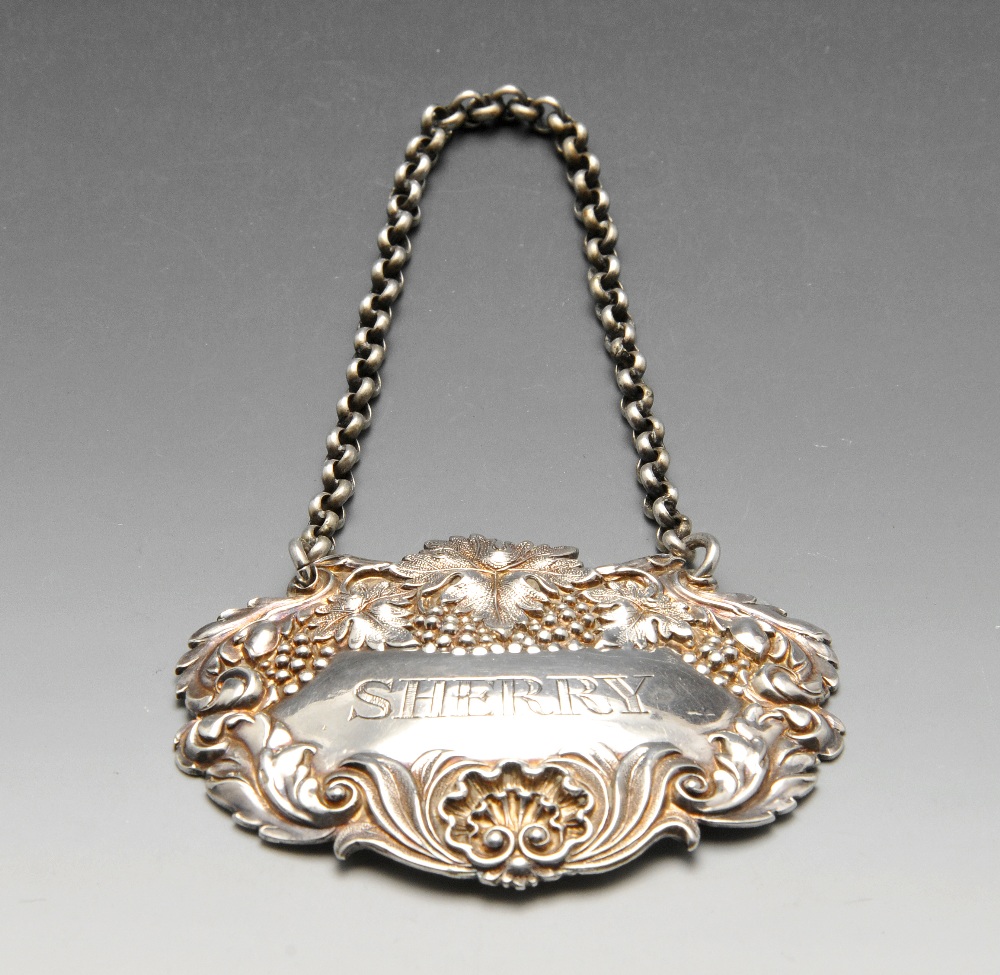 An early Victorian silver Sherry label with fruiting vine surround and suspended on belcher link