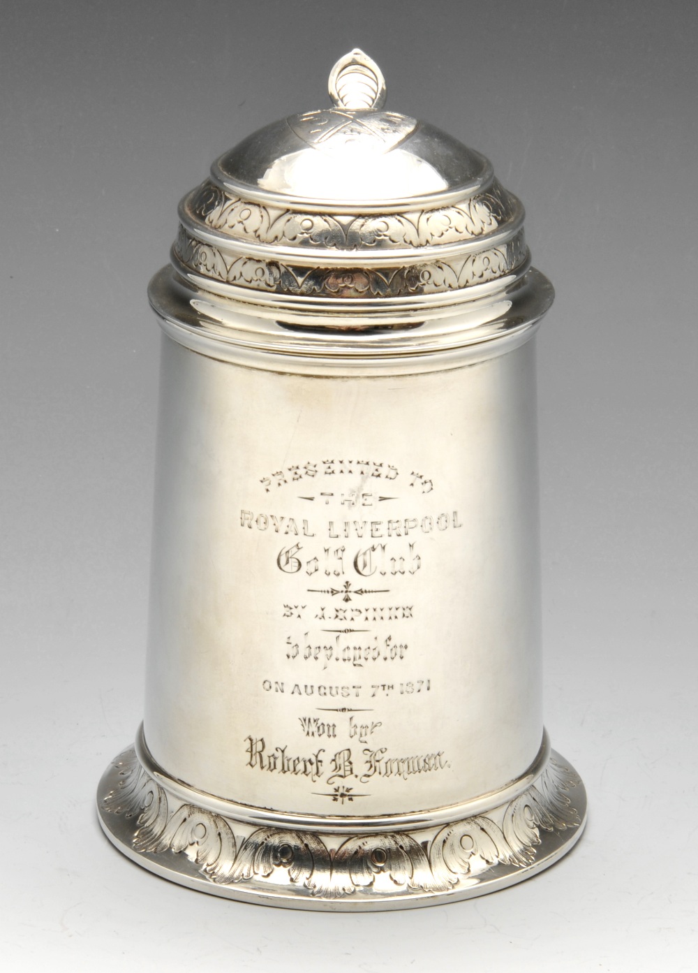 A mid-Victorian silver tankard of slightly tapering outline to a skirted base, the domed and