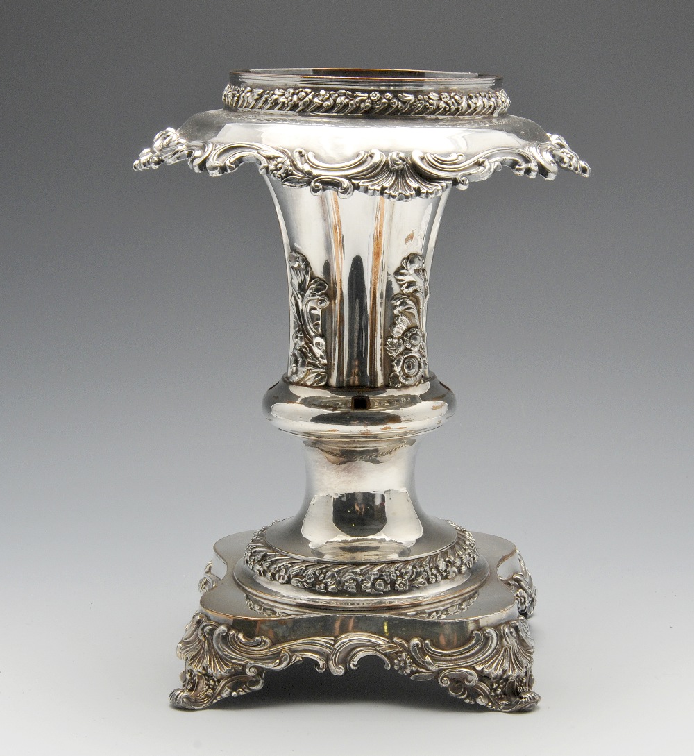 A plated epergne or table centrepiece decorated throughout with applied borders of floral and scroll