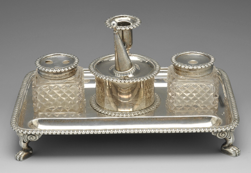 A George III silver desk stand, the oblong form standing on paw feet with ovolo border, dual