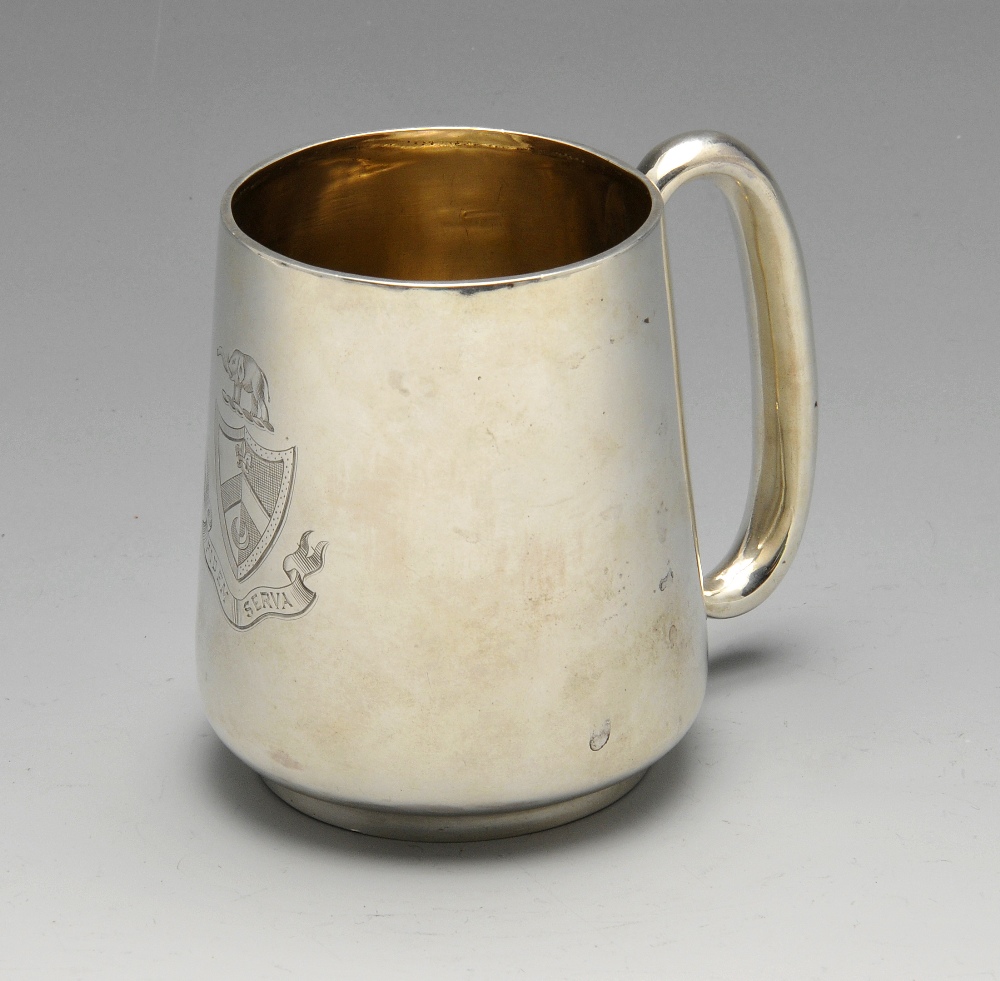 A Victorian silver christening mug, the plain tapered form with engraved crest and 'C' shaped