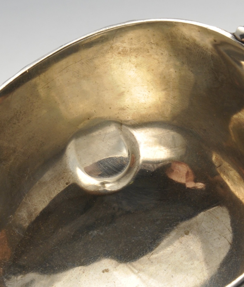 An early twentieth century silver sauce boat of typical form with ribbon and reed rim and raised - Image 6 of 6