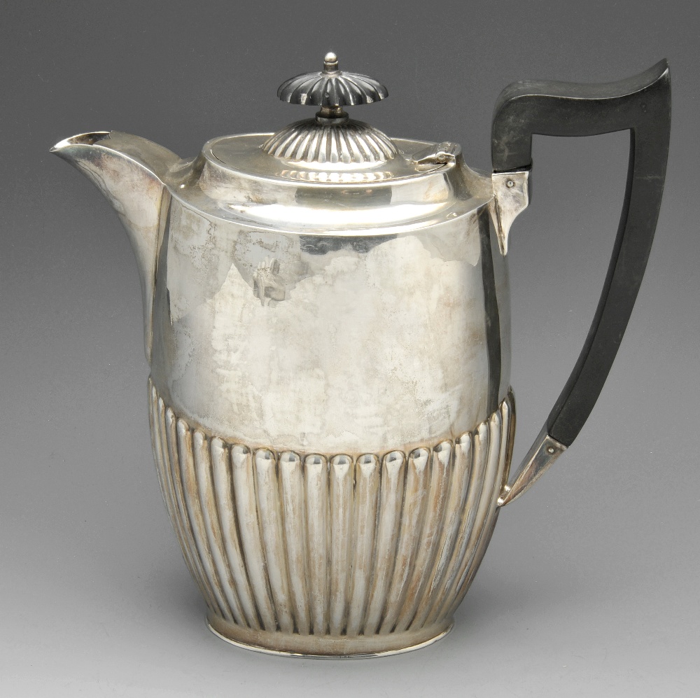 A 1920's silver teapot, of oval outline and part reeded form with applied ebonised handle and