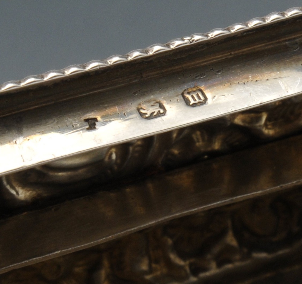 A late Victorian small silver box of oblong form, ornately embossed with floral and foliate - Image 3 of 8