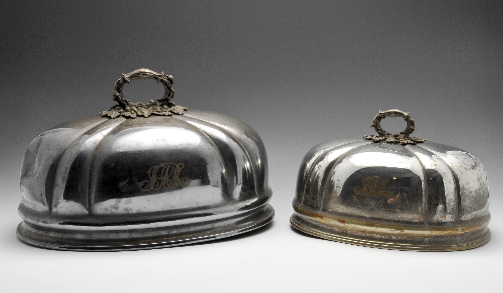 A graduated pair of silver plated meat covers with oak leaf and acorn handles, monogrammed, together