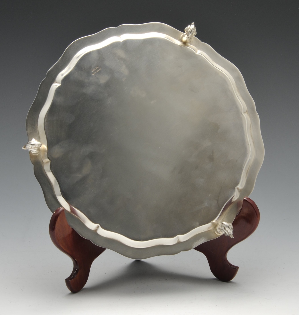 A modern silver salver the circular form with raised and shaped edge and standing on three scroll - Image 2 of 4