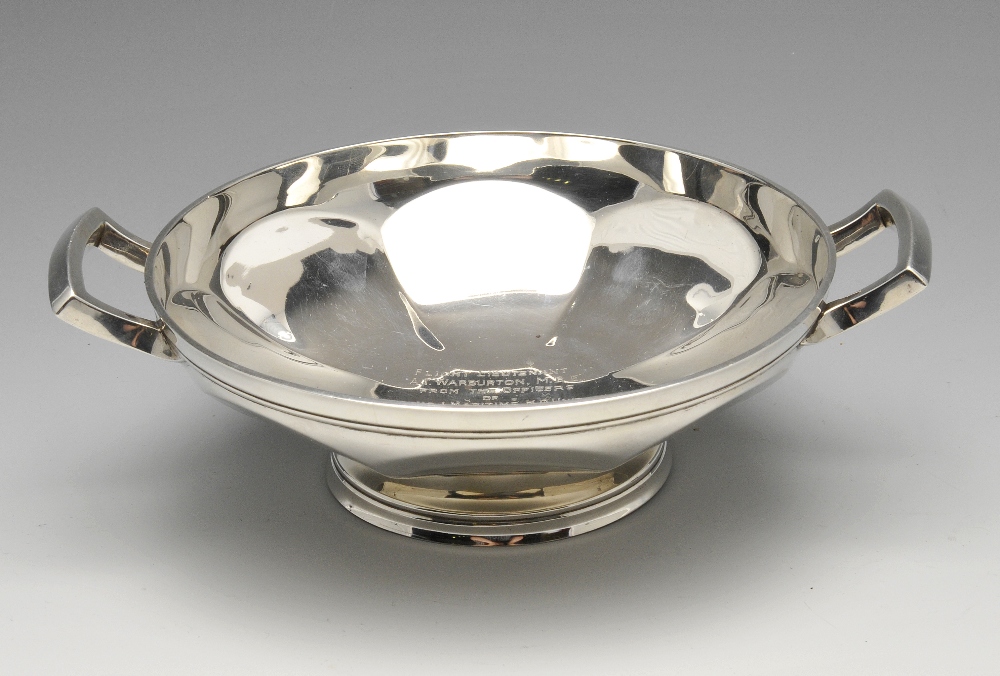 A 1920's silver twin-handled dish, of faceted circular form with central presentation inscription