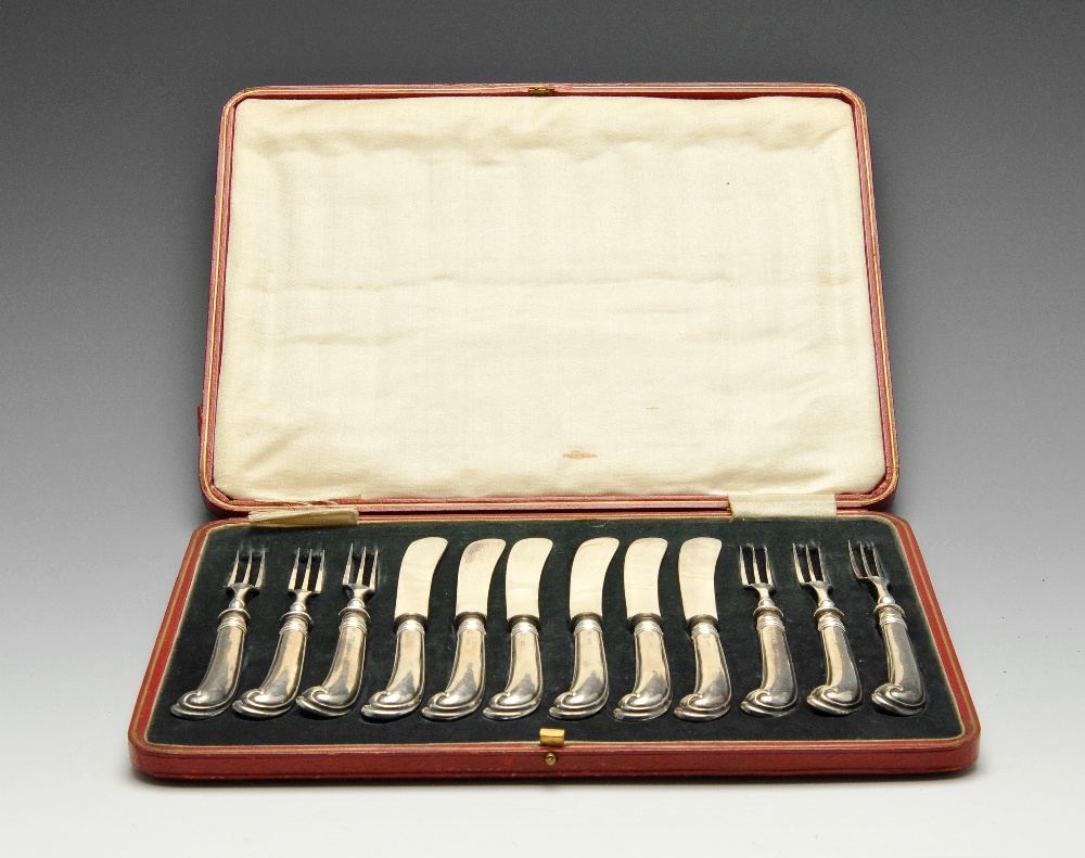 A cased set of early twentieth century silver handled pistol grip tea knives and forks for six place