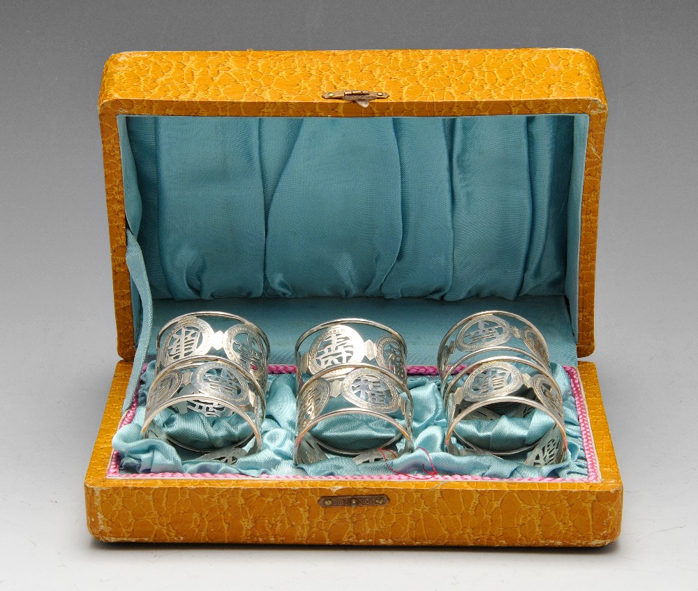 A cased set of six Chinese export napkin rings, each of circular openwork form with a band of